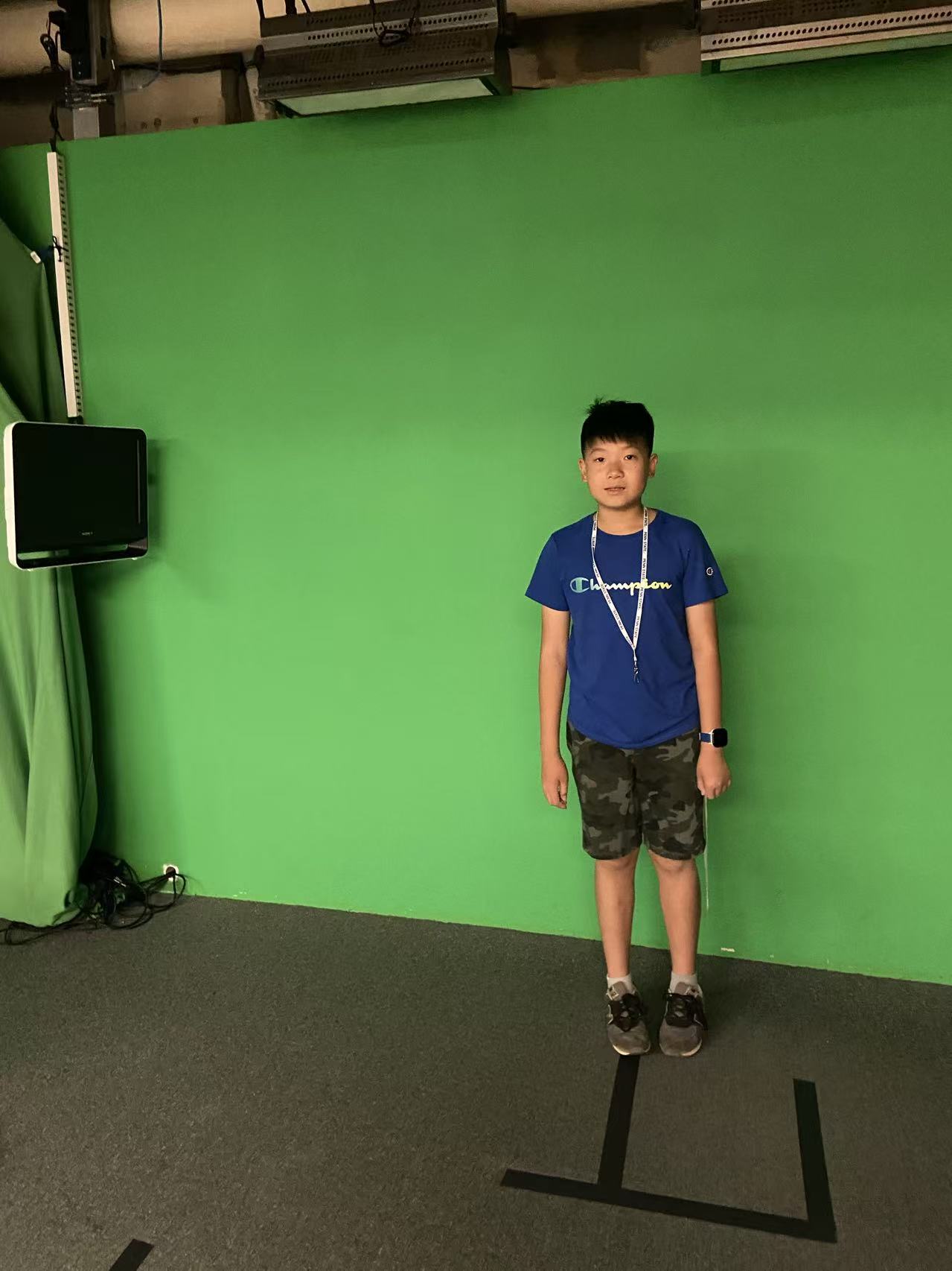 Calvin at a green screen during Penn State weather camp